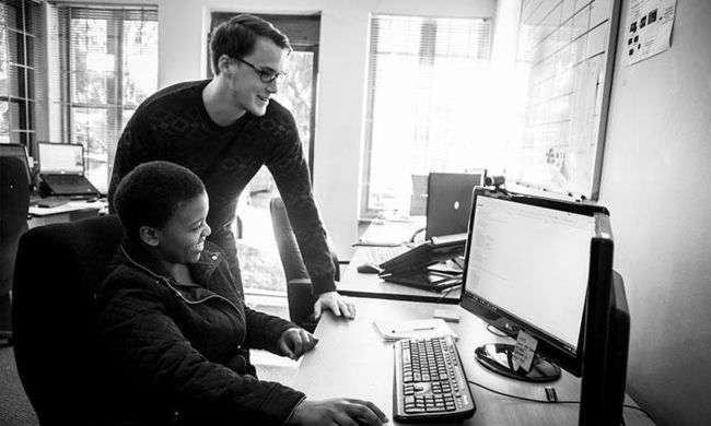 Two KRS developers working together behind a monitor