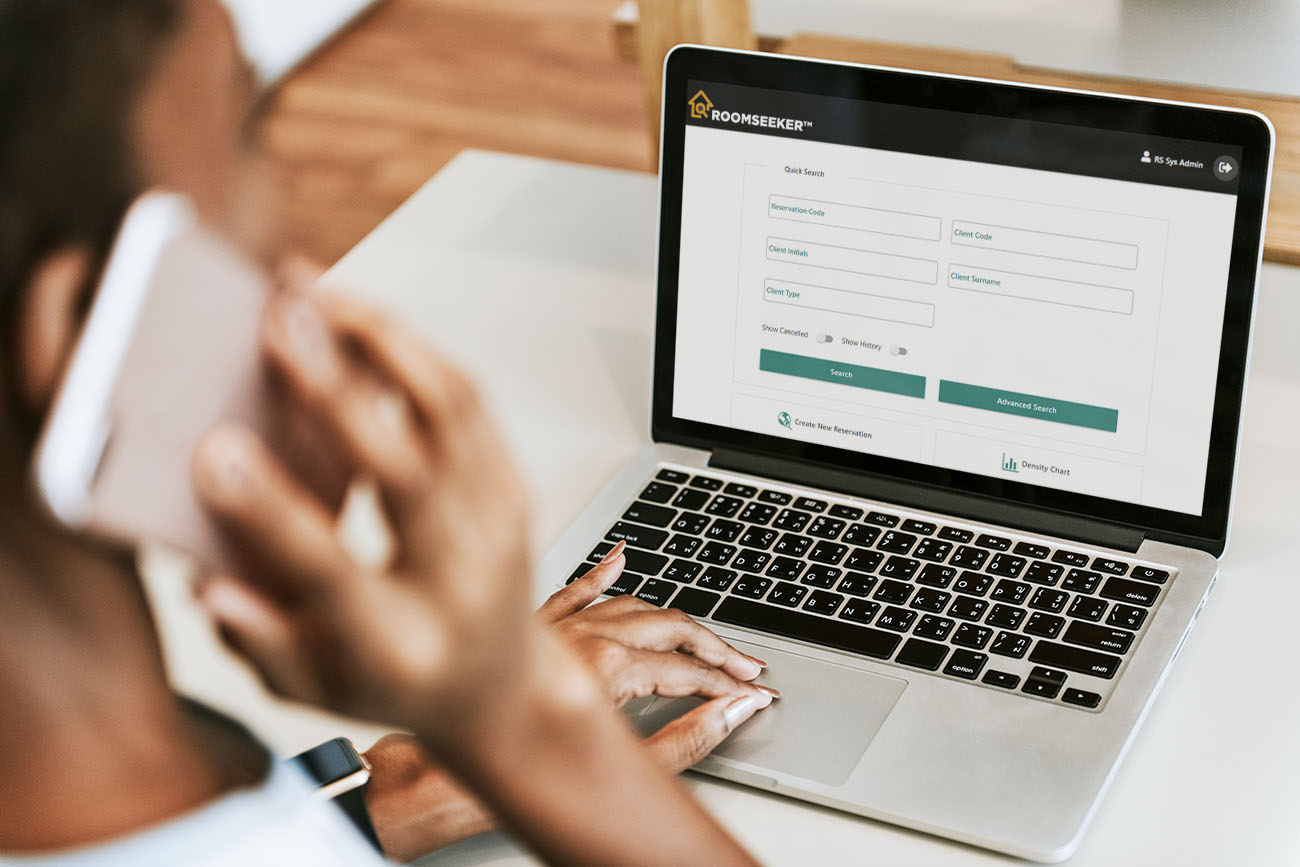 RoomSeeker Front Desk module by KRS displayed on laptop